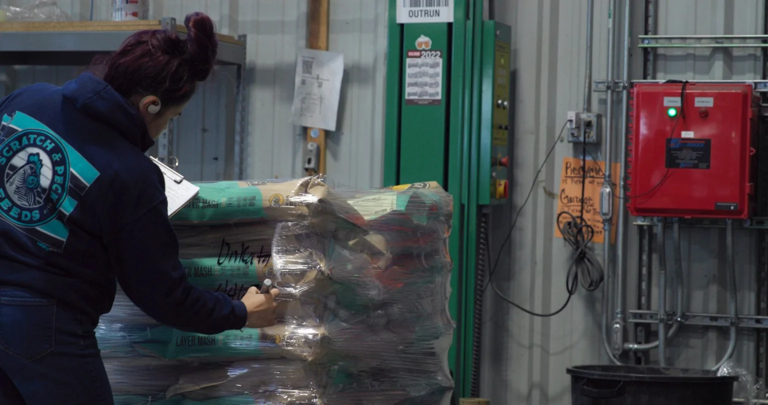 The organic seal is clearly visible from the outside, so no additional organic identifier is required. Here, the worker is adding the unique identifier (lot number or shipping ID).