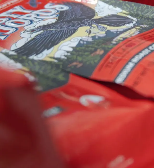Close-up of red organic coffee packages with illustrated eagle labels.